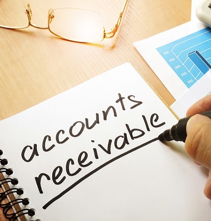 Accountant reviewing accounts receivable and invoice tracking for a UAE business